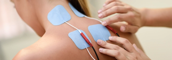 Chiropractic Quincy MA Electric Muscle Stimulation A person receiving Electric Muscle Stimulation therapy on their upper back.