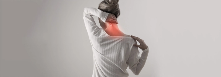 Chiropractic Quincy MA Neck Pain An individual holding their neck, with the neck area shown in red to indicate pain or discomfort.